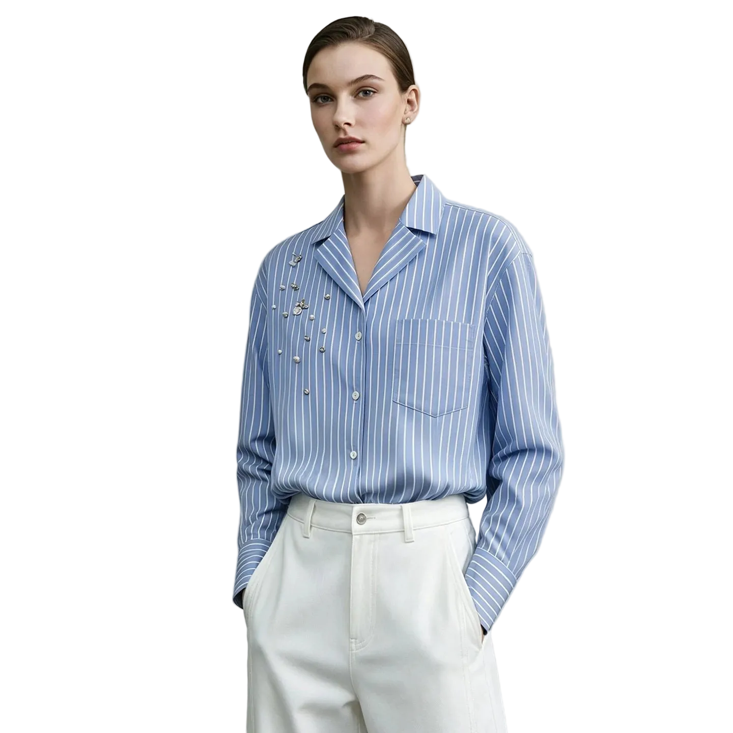 A model wearing an AMII light blue and white striped button-down shirt with pearl embellishments on the chest, paired with white trousers, set against a neutral gray background.