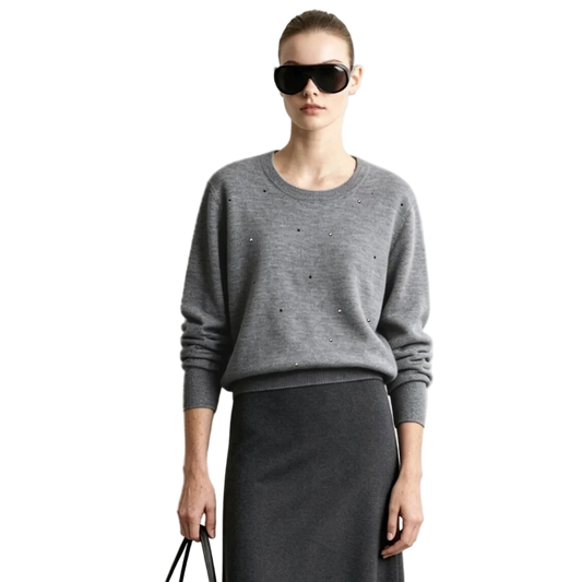 A model wearing an AMII gray knit crewneck sweater with small rhinestone embellishments, paired with a dark gray skirt and black sunglasses, against a plain white background.
