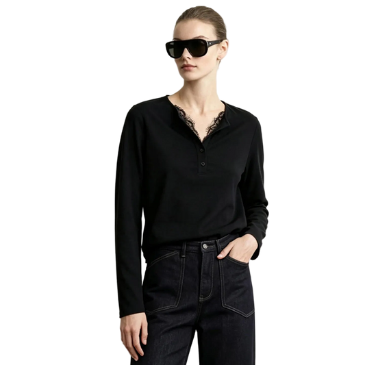A woman modeling a black long-sleeve Henley top with a lace V-neck trim, paired with dark jeans and black sunglasses, against a plain light gray background. The brand name AMII is printed in the top left corner.