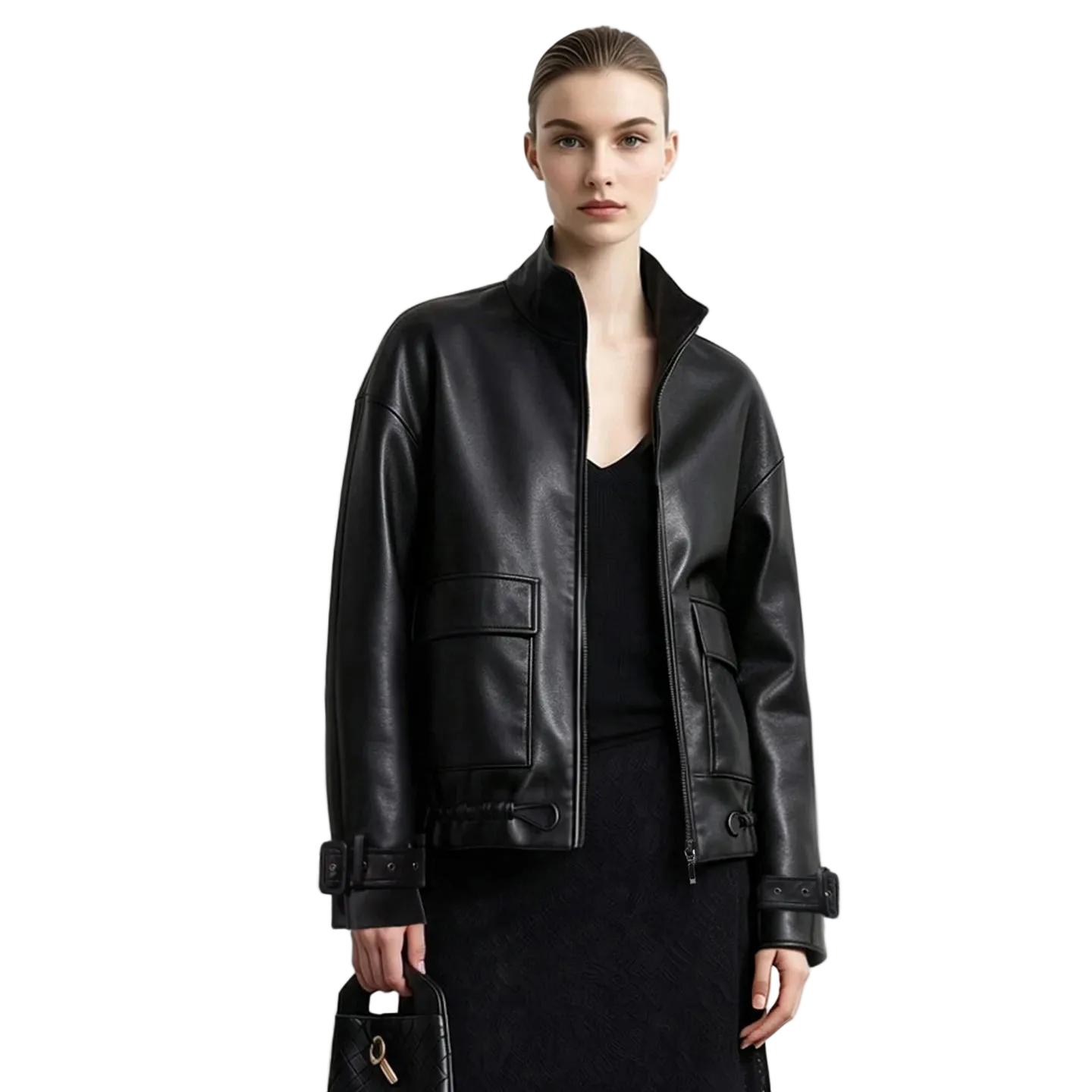 A model wearing a black leather jacket by AMII, styled with a black top and skirt, holding a black handbag against a plain white studio background.