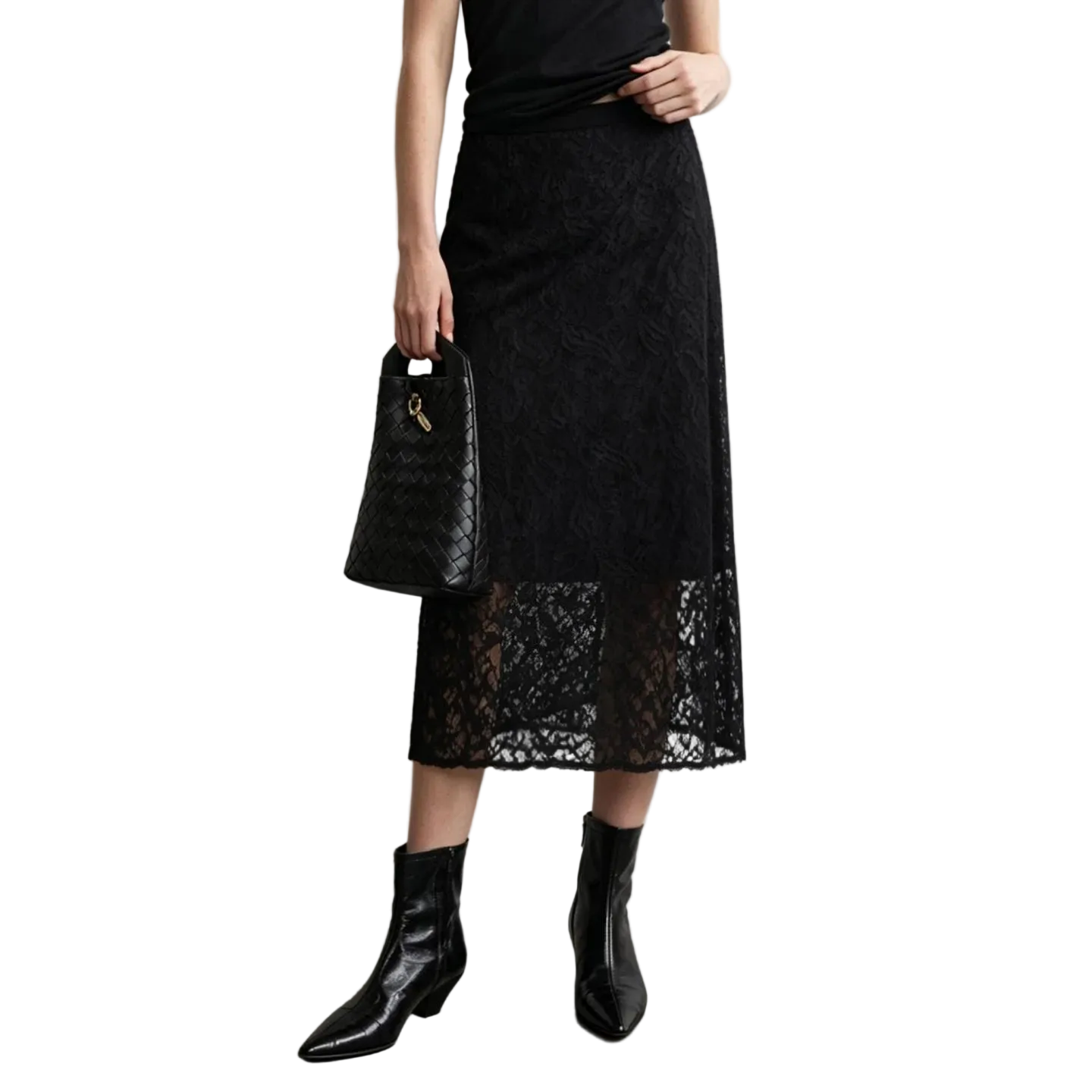 A model wearing a black lace midi skirt with a solid black overlay, paired with black leather ankle boots and holding a black woven handbag. The AMII brand logo is visible in the top left corner against a neutral gray studio background.