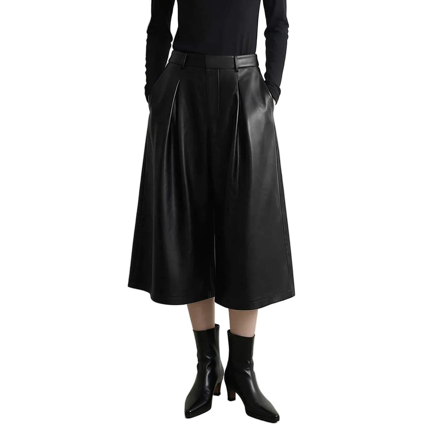 A model wearing a black faux leather wide-leg cropped skirt with pleats, paired with a black long-sleeve top and black pointed-toe ankle boots. The AMII brand logo is visible in the top left corner against a light gray studio background.